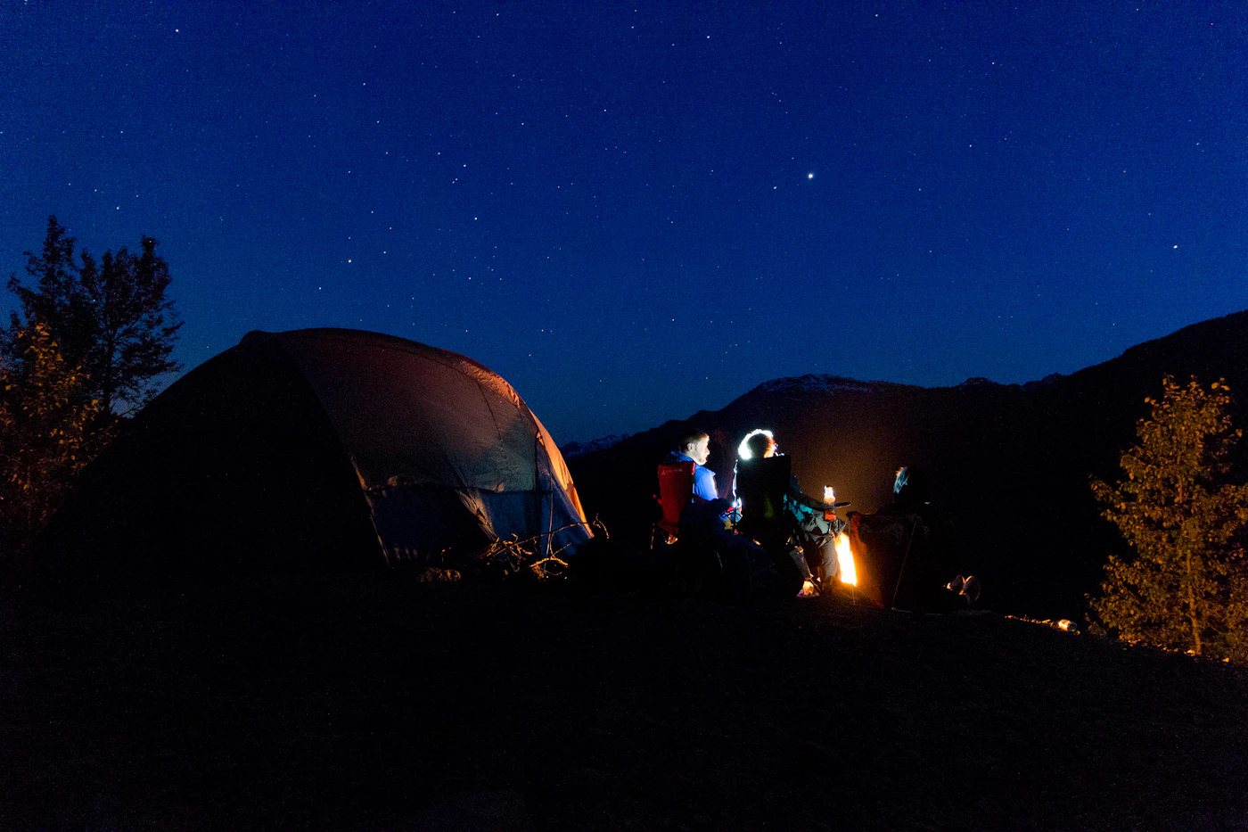 Tent glowing at dusk at a backcountry camp near Whistler, British Columbia