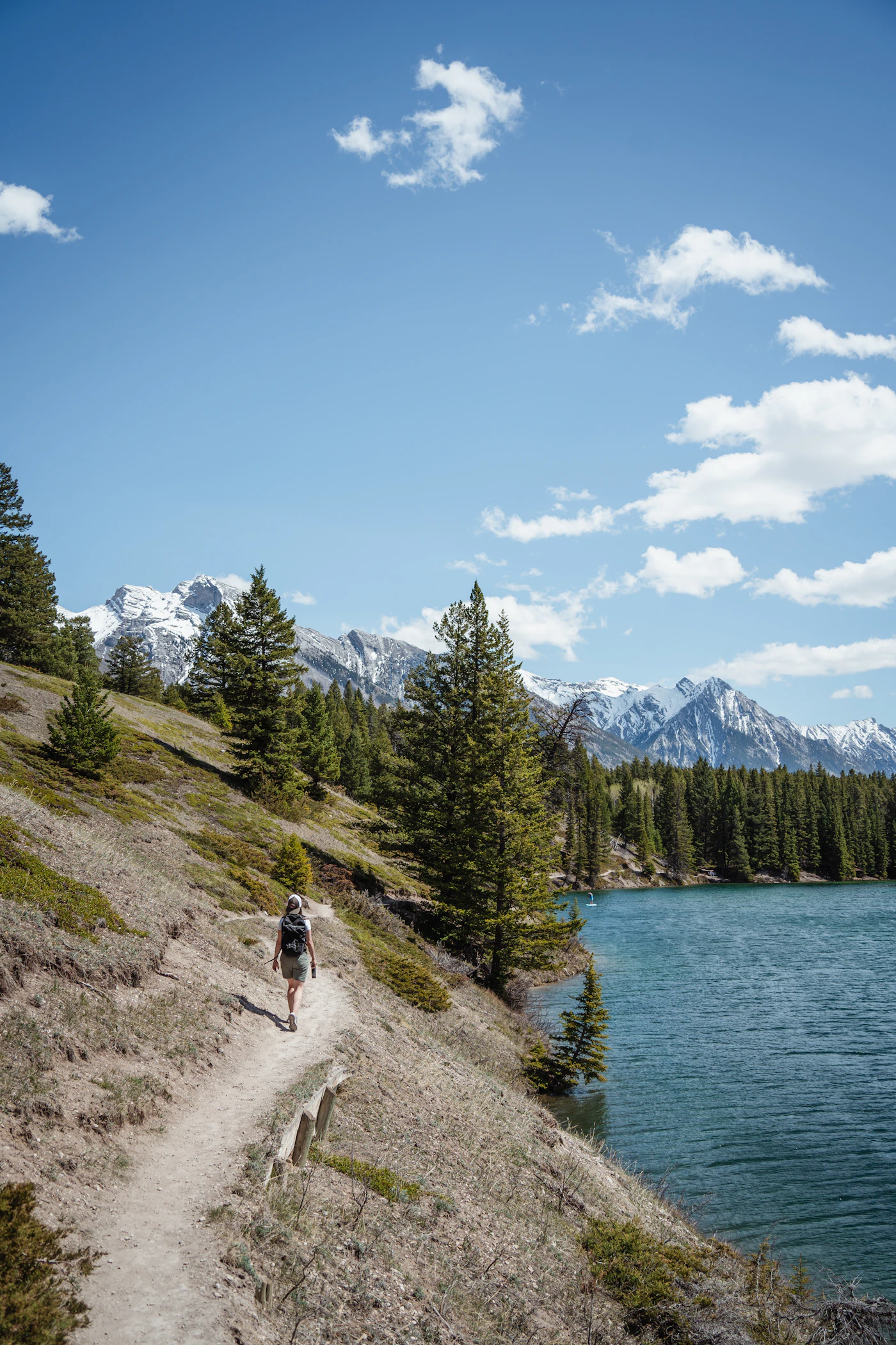 Hiker walking a forest trail near Johnson Lake, Banff National Park